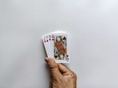 Hand holding a small stack of playing cards.