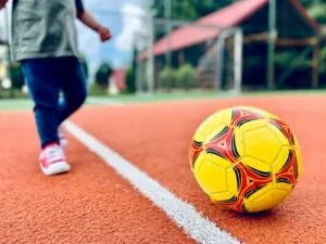 Child playing soccer on a field